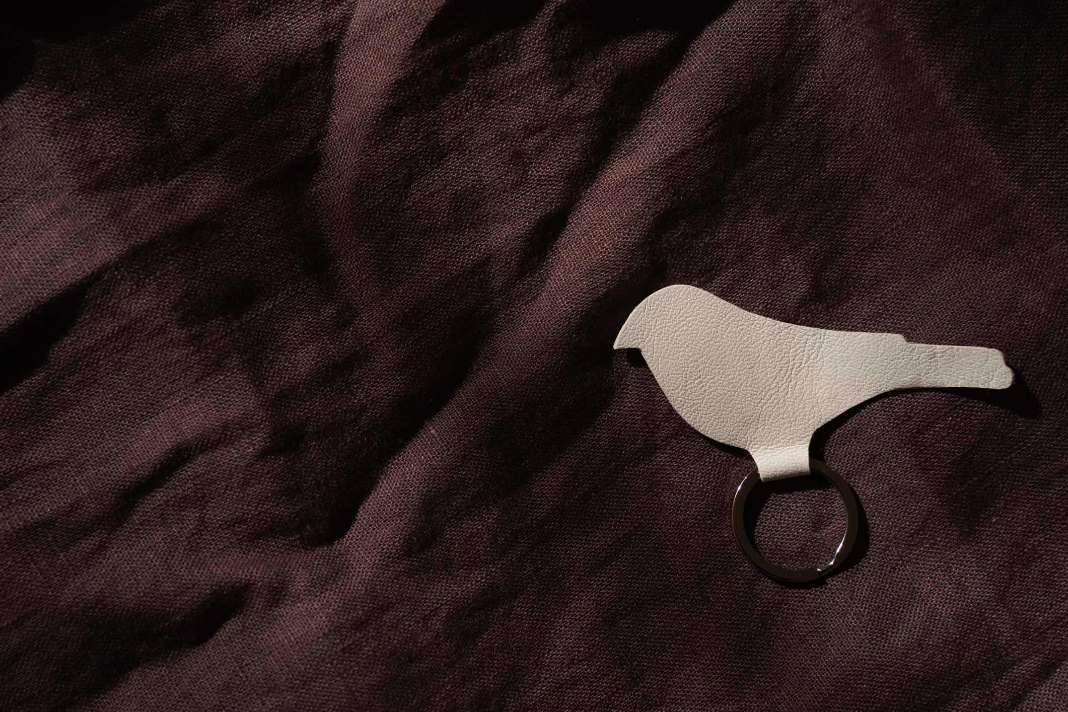 Textured gold bird keychain, handcrafted leather key ring, modern and elegant keychain for everyday use.