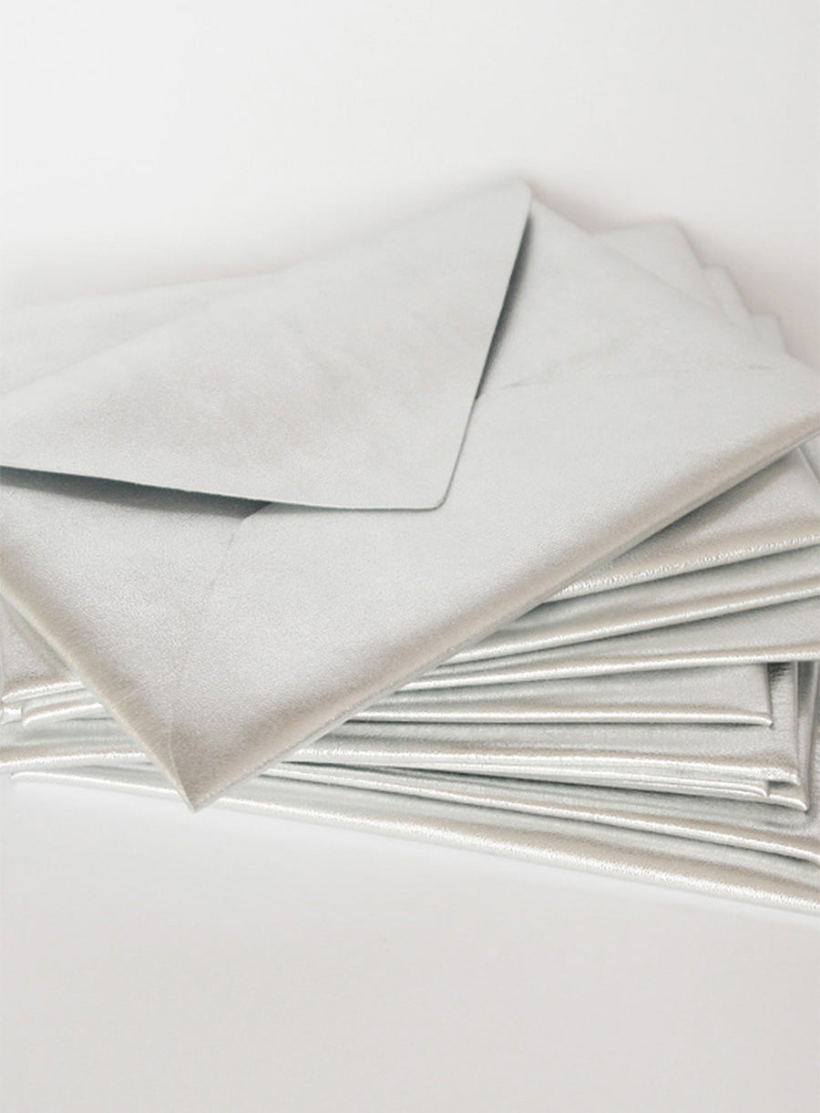 Stylish and unique wedding stationery set featuring dark leather envelopes, calligraphy escort cards, and a vintage proposal invitation. Perfect for historical, gothic, or literary-inspired weddings