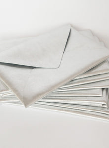 Stylish and unique wedding stationery set featuring dark leather envelopes, calligraphy escort cards, and a vintage proposal invitation. Perfect for historical, gothic, or literary-inspired weddings