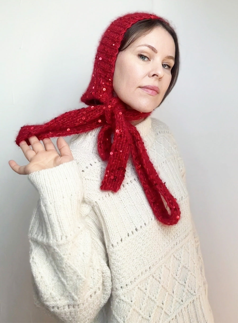 Red riding hood inspired bonnet for women, hand-knit with sequins. A stylish accessory for autumn outfits, fantasy cosplay, or cozy winter looks.