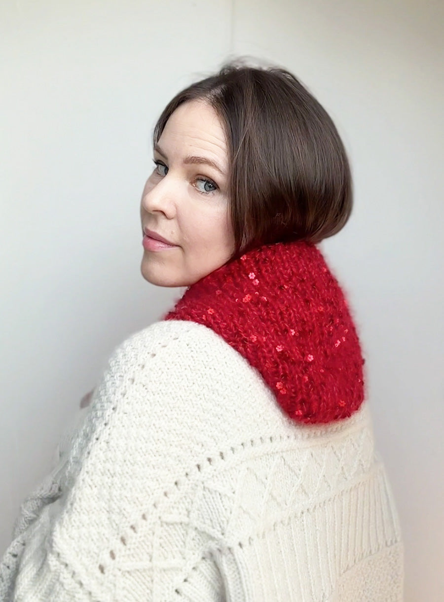 Close-up of a warm and soft red bonnet for women, made from luxury yarn with sequins. Ideal for Little Red Riding Hood costume or gift for her.