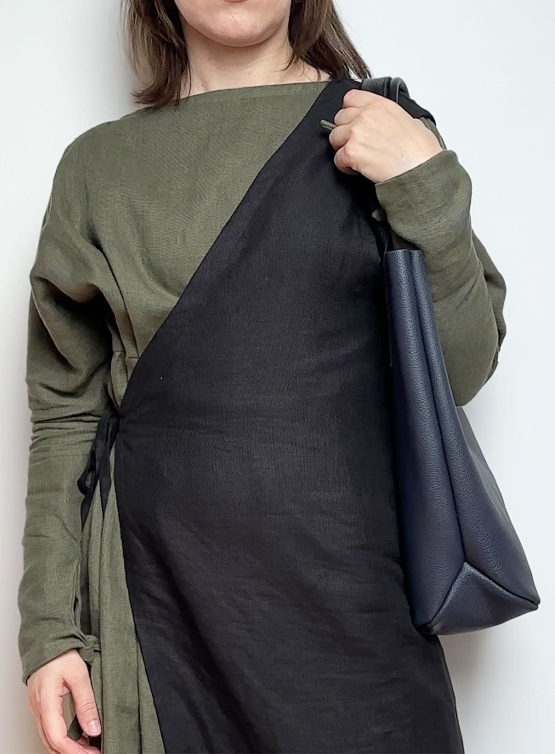 Interior of the unlined navy blue leather tote bag, displaying the natural suede finish and key hook