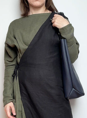 Interior of the unlined navy blue leather tote bag, displaying the natural suede finish and key hook