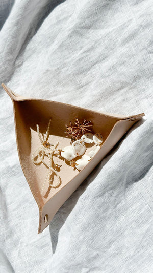Handmade leather catchall tray with metal stitch markers, perfect for organizing small craft supplies