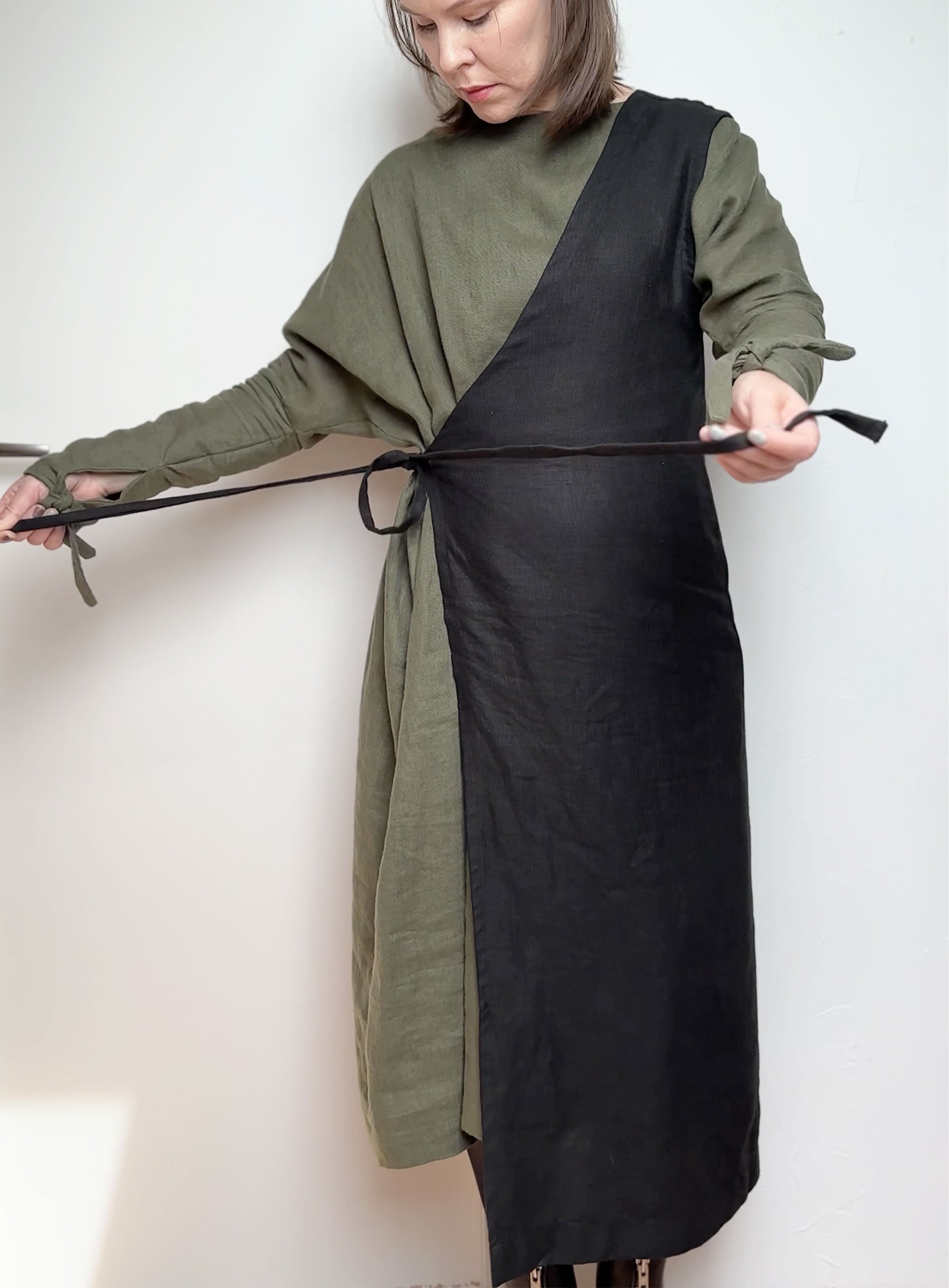 Model wearing the Linen asimetric vest  in blackover the dress 