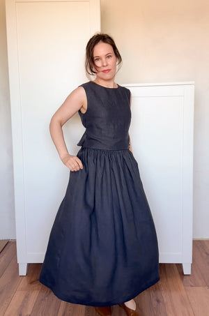Elegant and breathable black linen ensemble with a structured sleeveless top and relaxed gathered skirt
