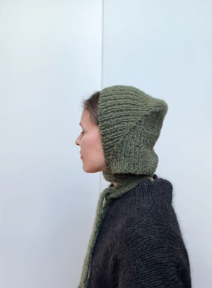 Hand-knitted mohair bonnet in earthy green, stylish and warm winter hat with ties, soft handmade accessory perfect for cozy fall and winter outfits.