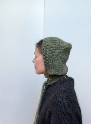 Hand-knitted mohair bonnet in earthy green, stylish and warm winter hat with ties, soft handmade accessory perfect for cozy fall and winter outfits.