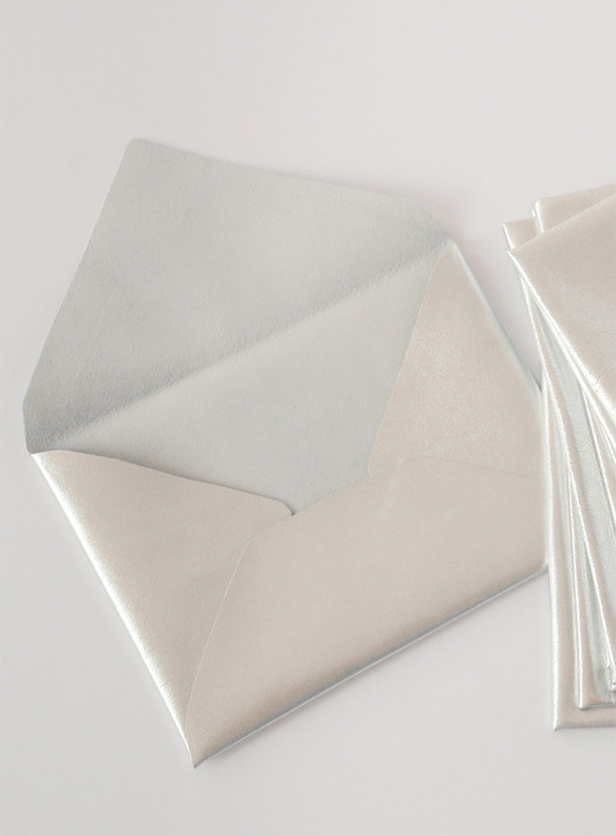 Stylish and unique wedding stationery set featuring dark leather envelopes, calligraphy escort cards, and a vintage proposal invitation. Perfect for historical, gothic, or literary-inspired weddings