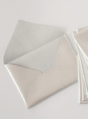 Stylish and unique wedding stationery set featuring dark leather envelopes, calligraphy escort cards, and a vintage proposal invitation. Perfect for historical, gothic, or literary-inspired weddings
