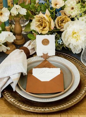 Rustic wedding invitation suite with leather-bound details, wax-sealed envelopes, and vintage-inspired typography. Unique, handcrafted design for an unforgettable wedding announcement.